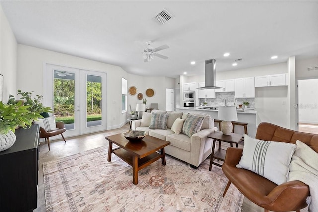 living area with ceiling fan, french doors, visible vents, and recessed lighting
