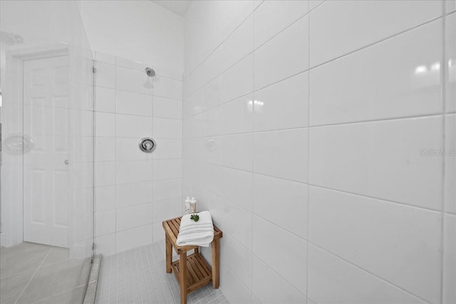 full bathroom with a tile shower and tile patterned floors