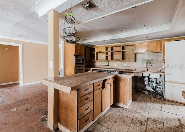 11120 5th St E, Treasure Island, FL 33706 - kitchen with a raised ceiling, a textured ceiling, open shelves, crown molding, and tile countertops