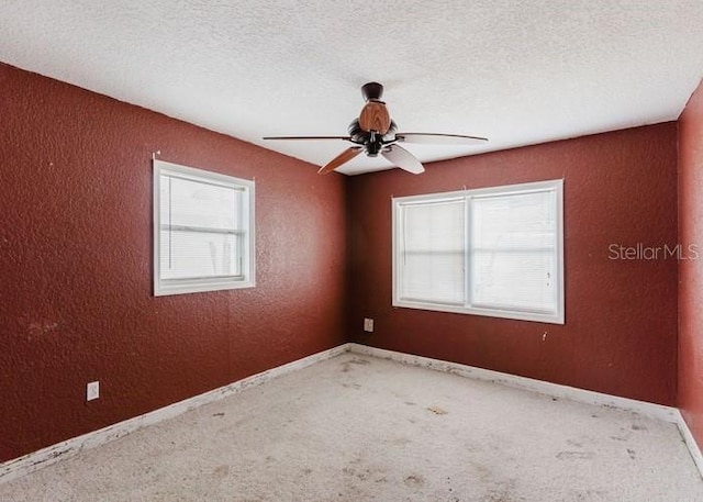 11120 5th St E, Treasure Island, FL 33706 - carpeted empty room with a ceiling fan, a textured wall, a textured ceiling, and baseboards