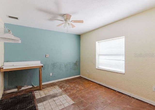 11120 5th St E, Treasure Island, FL 33706 - unfurnished living room featuring ceiling fan and baseboards