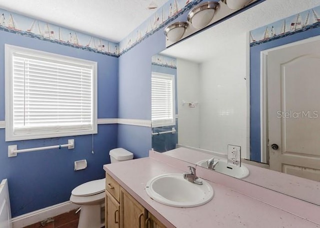 11120 5th St E, Treasure Island, FL 33706 - bathroom with vanity, toilet, and baseboards