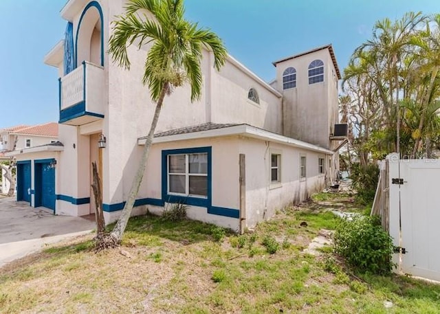 11120 5th St E, Treasure Island, FL 33706 - view of home's exterior with stucco siding and a balcony