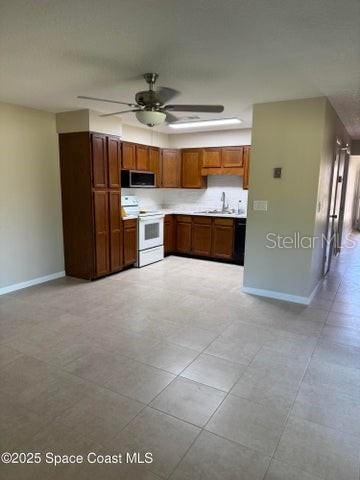 kitchen featuring light countertops, baseboards, stainless steel microwave, electric stove, and ceiling fan