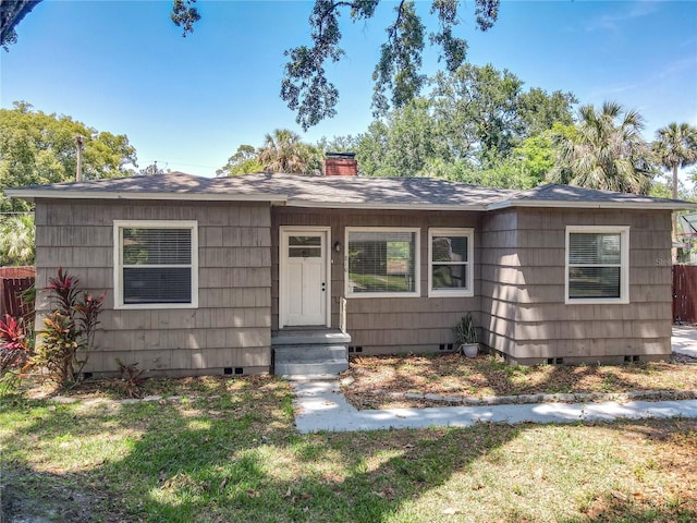 bungalow with crawl space, a chimney, and a shingled roof