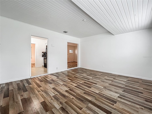 unfurnished room featuring wood finished floors and baseboards