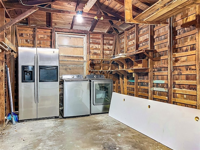 misc room with washer and clothes dryer and unfinished concrete flooring