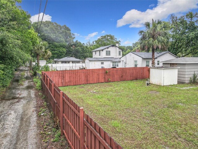 view of yard with a storage shed and an outbuilding