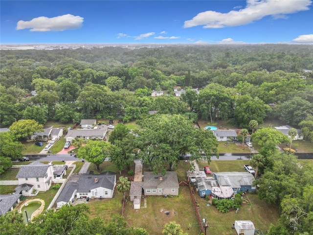 view of property location featuring a heavily wooded area and nearby suburban area