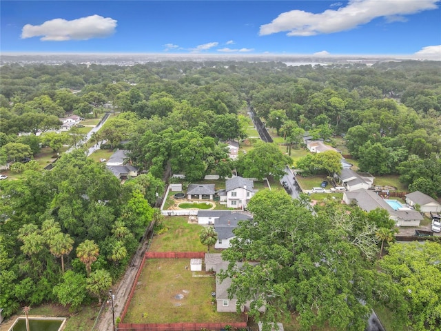 aerial view of residential area featuring a forest