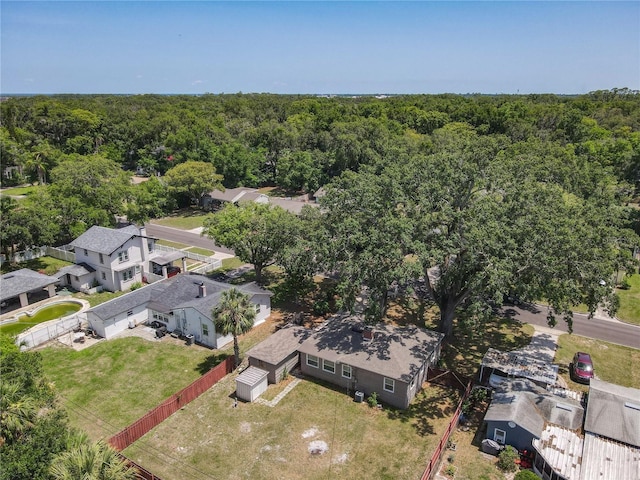 aerial view of property and surrounding area featuring a heavily wooded area