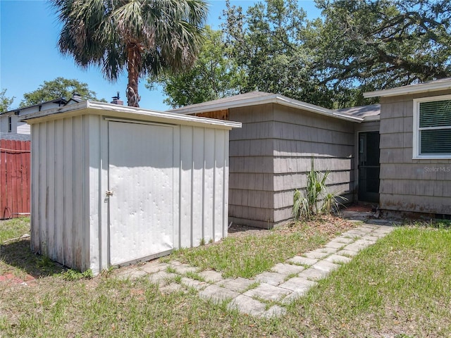 view of shed featuring fence