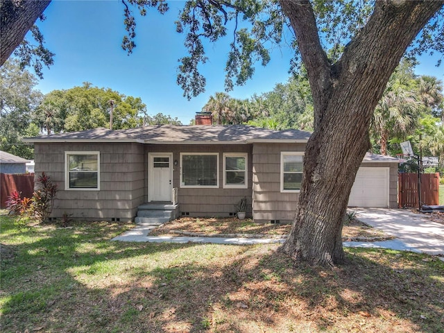 view of front of property with crawl space, a chimney, concrete driveway, a garage, and roof with shingles