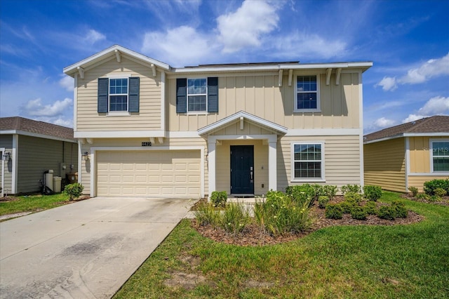 4423 Blackbird St, Kissimmee, FL 34746 - view of front of home featuring board and batten siding, concrete driveway, a garage, and a front lawn