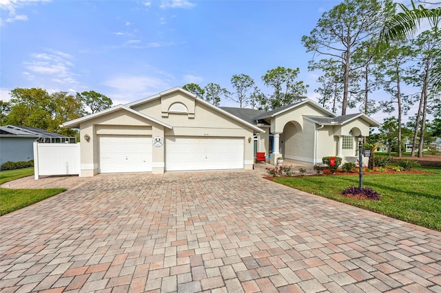 2444 Grandfather Mtn, Spring Hill, FL 34606 - ranch-style home featuring decorative driveway, stucco siding, and an attached garage
