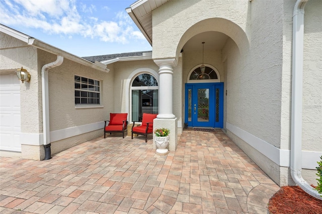 2444 Grandfather Mtn, Spring Hill, FL 34606 - property entrance with stucco siding and an attached garage