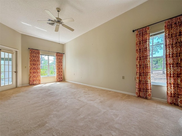 2444 Grandfather Mtn, Spring Hill, FL 34606 - unfurnished room with a textured ceiling, vaulted ceiling, carpet floors, a ceiling fan, and baseboards