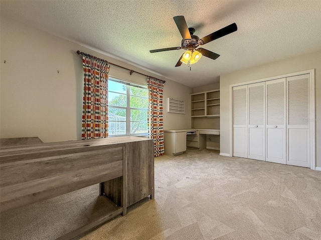 2444 Grandfather Mtn, Spring Hill, FL 34606 - unfurnished bedroom with carpet flooring, a textured ceiling, a desk, a ceiling fan, and a closet