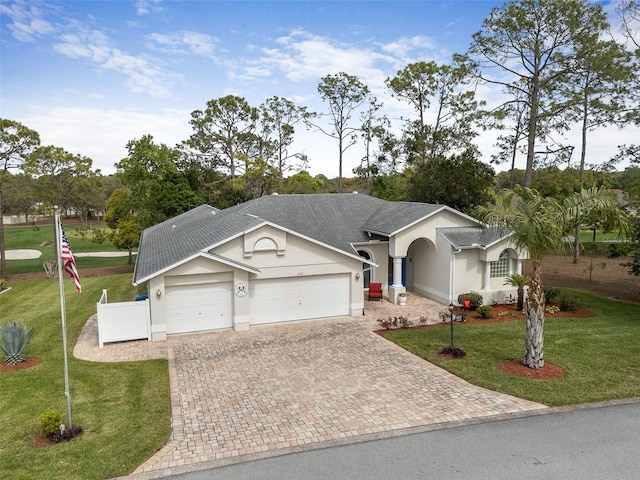 2444 Grandfather Mtn, Spring Hill, FL 34606 - ranch-style house with decorative driveway, a garage, stucco siding, and a front lawn