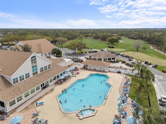 2444 Grandfather Mtn, Spring Hill, FL 34606 - community pool featuring golf course view, view of scattered trees, and a patio area