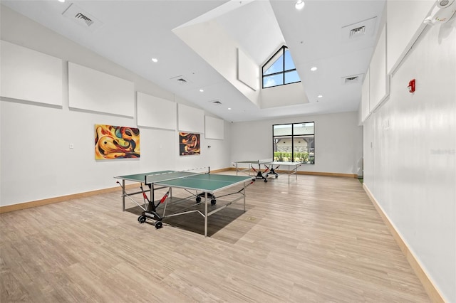 2444 Grandfather Mtn, Spring Hill, FL 34606 - recreation room with light wood-type flooring, high vaulted ceiling, and baseboards
