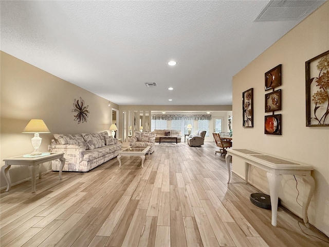 2436 Deer Trail Ln, Spring Hill, FL 34606 - living room featuring light wood-style flooring, recessed lighting, and a textured ceiling
