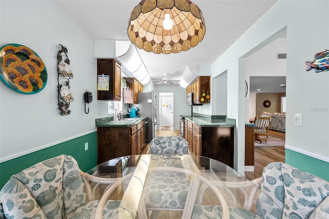 2436 Deer Trail Ln, Spring Hill, FL 34606 - dining space with light wood-style flooring, ceiling fan, and baseboards