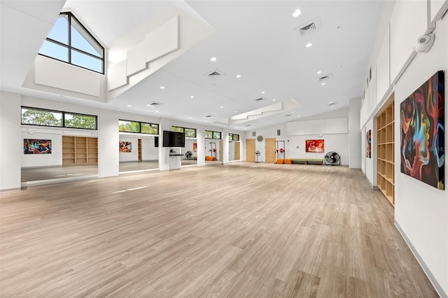 2436 Deer Trail Ln, Spring Hill, FL 34606 - workout area featuring light wood-style floors, recessed lighting, and high vaulted ceiling
