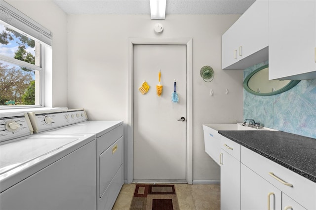 2436 Deer Trail Ln, Spring Hill, FL 34606 - laundry area with washing machine and clothes dryer, cabinet space, light tile patterned flooring, and a textured ceiling