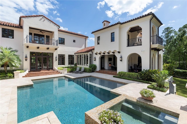 10138 Enchanted Oak Dr, Golden Oak, FL 32836 - rear view of property featuring a ceiling fan, a patio, a tile roof, a balcony, and french doors