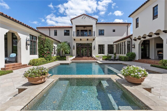 10138 Enchanted Oak Dr, Golden Oak, FL 32836 - outdoor pool featuring a patio area, an in ground hot tub, and a ceiling fan