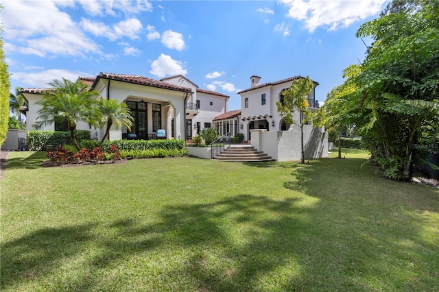 10138 Enchanted Oak Dr, Golden Oak, FL 32836 - back of house featuring a tile roof, a lawn, and stucco siding