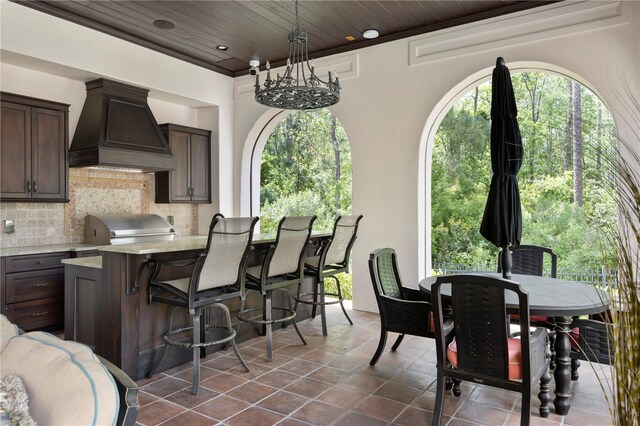 10138 Enchanted Oak Dr, Golden Oak, FL 32836 - exterior space featuring recessed lighting, dark tile patterned floors, wooden ceiling, and a healthy amount of sunlight