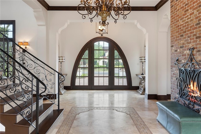 10138 Enchanted Oak Dr, Golden Oak, FL 32836 - entrance foyer featuring arched walkways, a notable chandelier, baseboards, and crown molding
