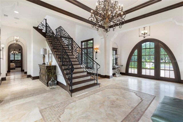 10138 Enchanted Oak Dr, Golden Oak, FL 32836 - entrance foyer featuring an inviting chandelier, stairway, french doors, crown molding, and arched walkways