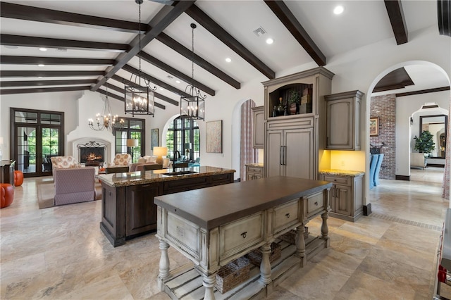 10138 Enchanted Oak Dr, Golden Oak, FL 32836 - kitchen featuring arched walkways, a kitchen island with sink, a healthy amount of sunlight, paneled built in fridge, and high vaulted ceiling