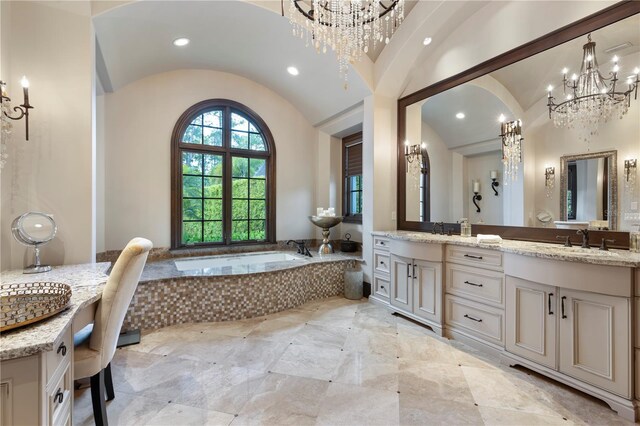 10138 Enchanted Oak Dr, Golden Oak, FL 32836 - bathroom featuring a sink, double vanity, an inviting chandelier, lofted ceiling, and a garden tub
