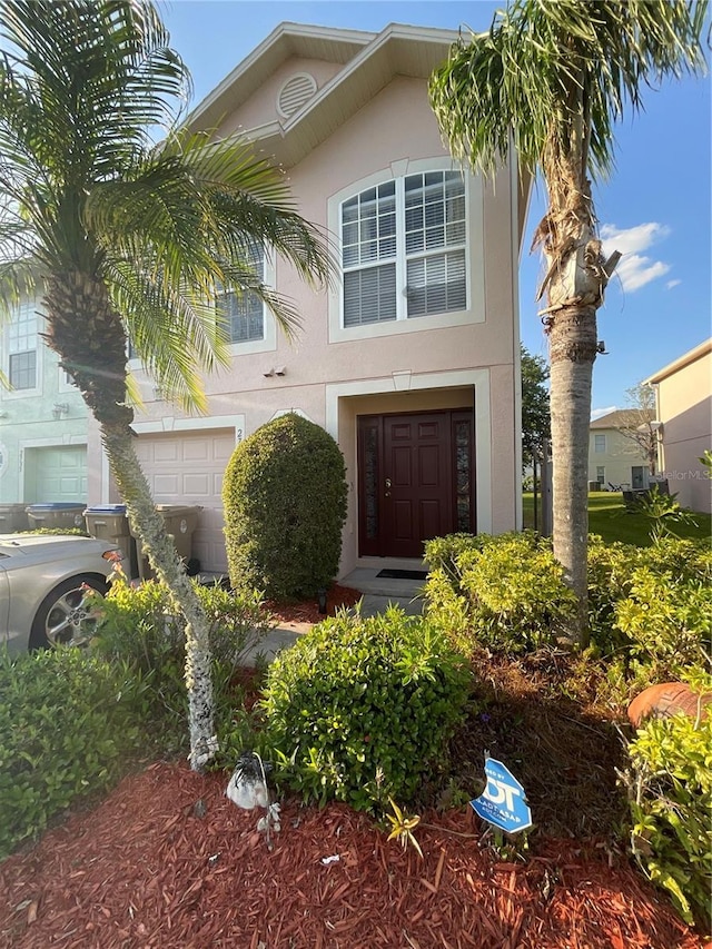 2737 Merrieweather Ln, Kissimmee, FL 34743 - view of front facade with a garage and stucco siding