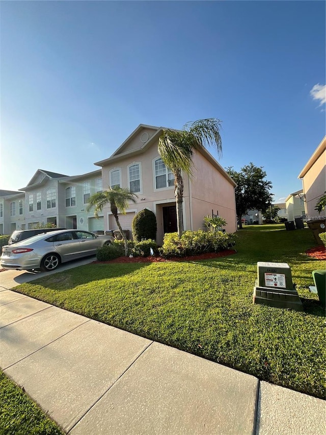 2737 Merrieweather Ln, Kissimmee, FL 34743 - view of front of house with a front lawn, a residential view, and stucco siding
