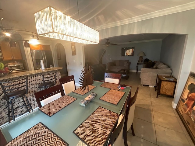 2737 Merrieweather Ln, Kissimmee, FL 34743 - dining area featuring ornamental molding, a toaster, light tile patterned flooring, ceiling fan, and arched walkways
