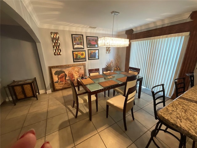 2737 Merrieweather Ln, Kissimmee, FL 34743 - dining room featuring a notable chandelier, baseboards, ornamental molding, light tile patterned floors, and arched walkways