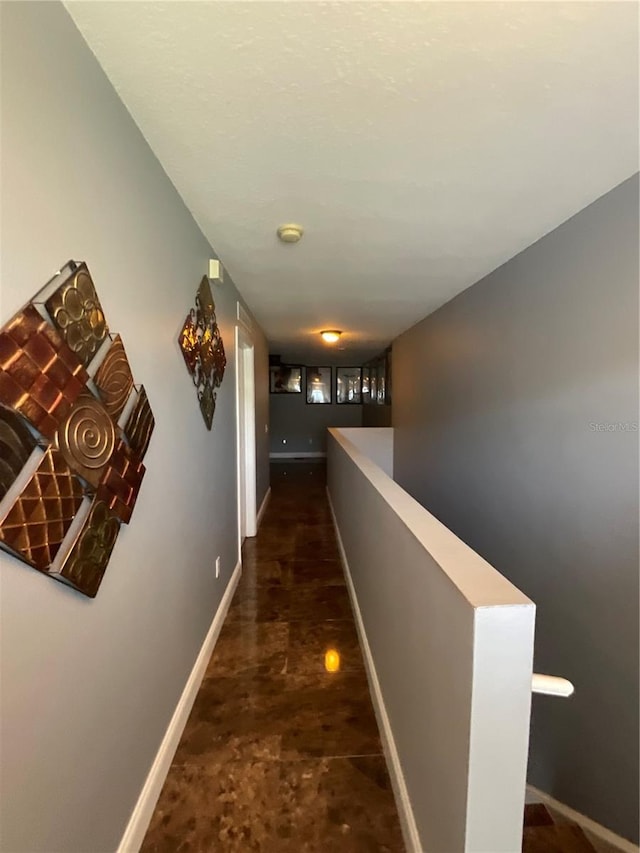 2737 Merrieweather Ln, Kissimmee, FL 34743 - hallway with baseboards and an upstairs landing