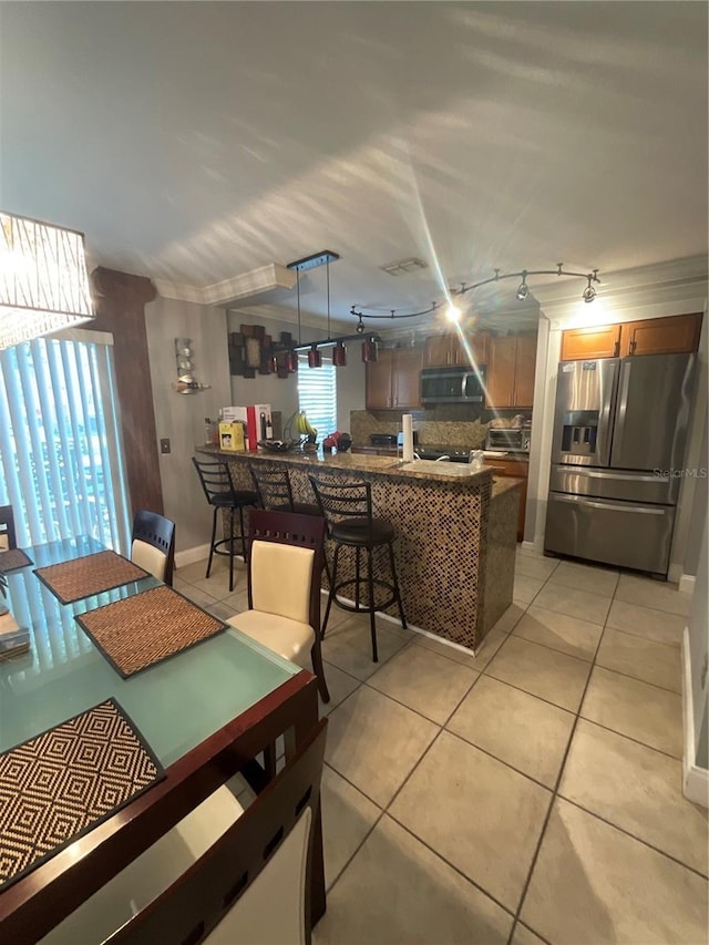 2737 Merrieweather Ln, Kissimmee, FL 34743 - dining area with light tile patterned floors, baseboards, and a toaster