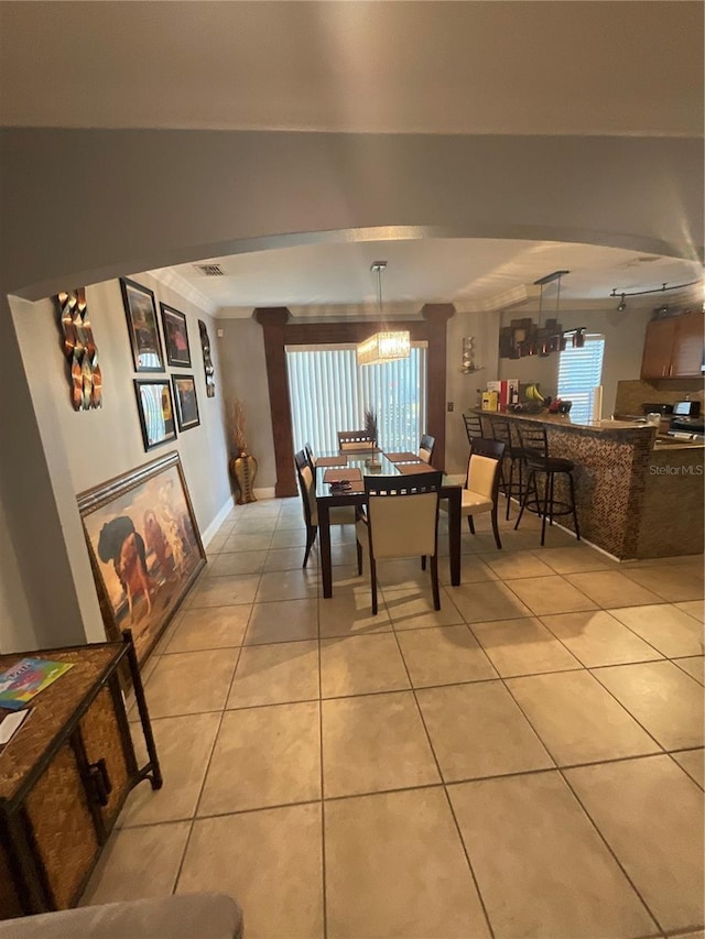 2737 Merrieweather Ln, Kissimmee, FL 34743 - dining space with crown molding, light tile patterned flooring, and baseboards
