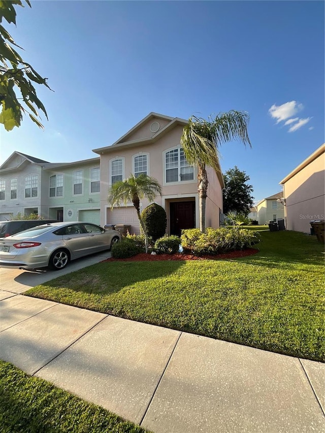 2737 Merrieweather Ln, Kissimmee, FL 34743 - view of front of house featuring driveway, stucco siding, and a front lawn