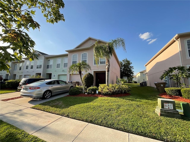 2737 Merrieweather Ln, Kissimmee, FL 34743 - view of front of property with stucco siding, a front yard, an attached garage, driveway, and a residential view