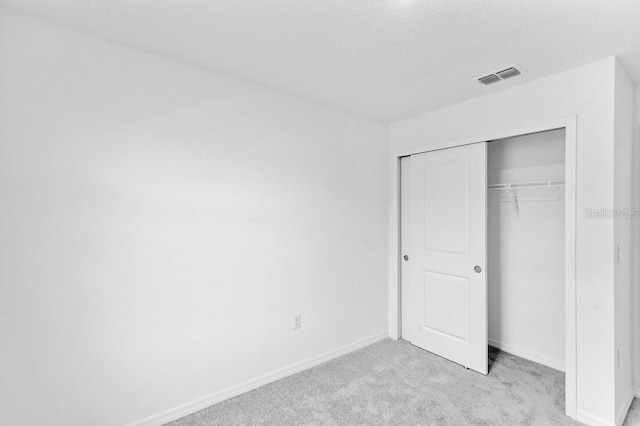 182 River Front Way, Edgewater, FL 32141 - unfurnished bedroom with visible vents, baseboards, a closet, and light carpet
