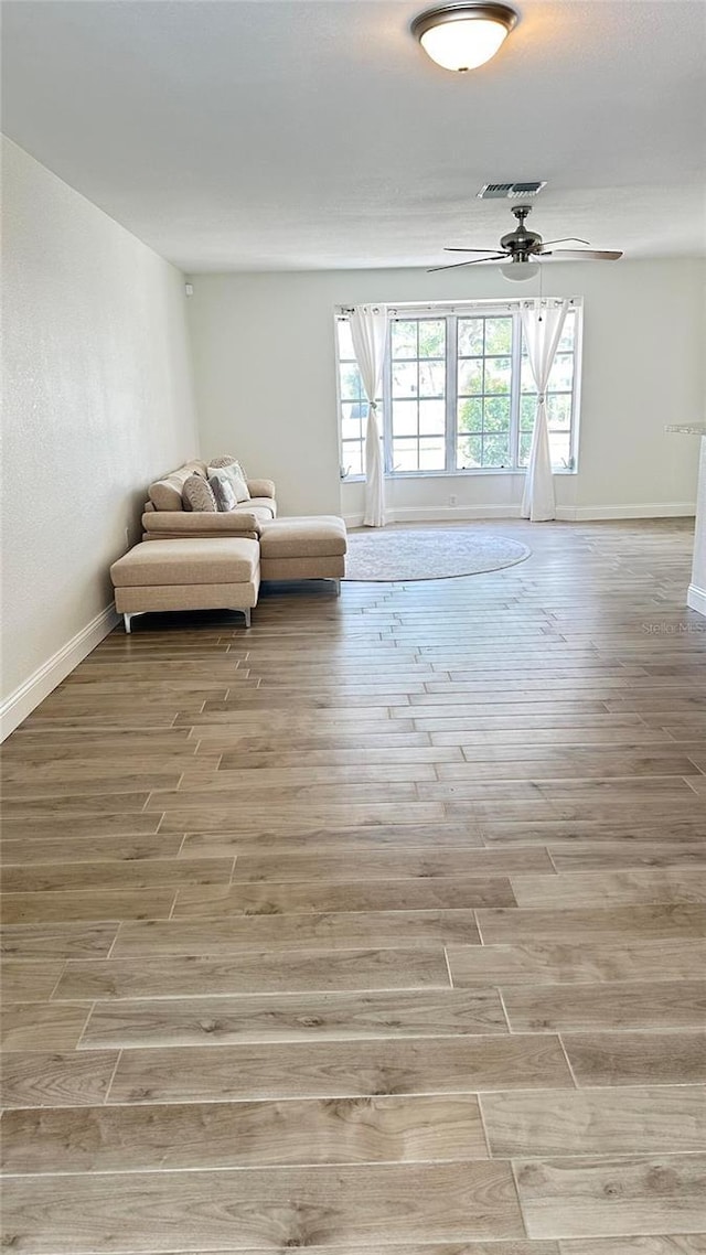 sitting room featuring light wood-style flooring and baseboards