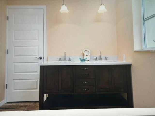 bathroom with double vanity and wood finished floors