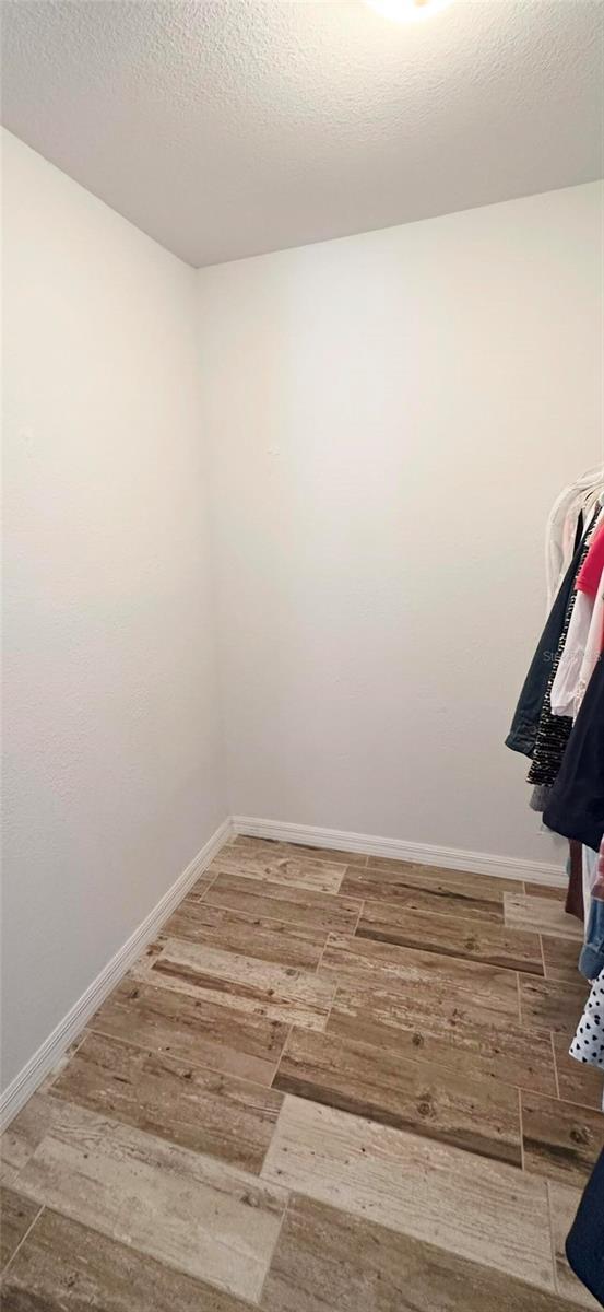 spacious closet with wood finished floors